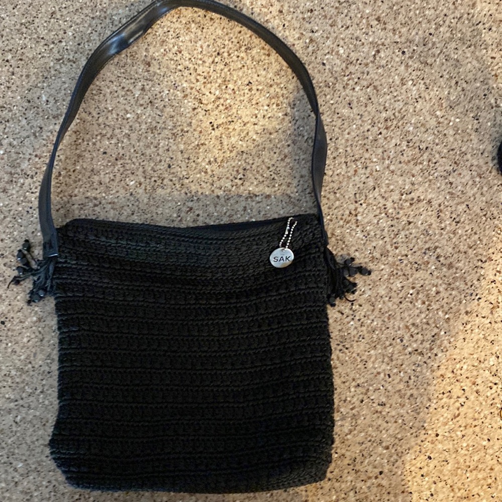 The Sak black hand crocheted purse with leather shoulder strap.